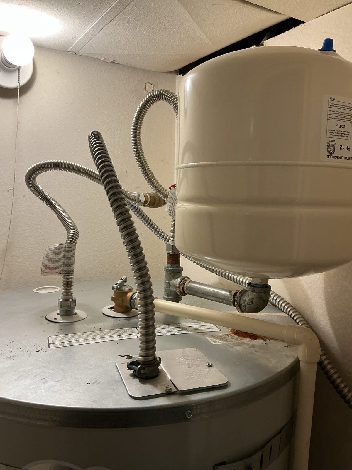 Before: galvanized steel pipe and fittings on a 4-year-old water heater and expansion tank in Marysville, WA