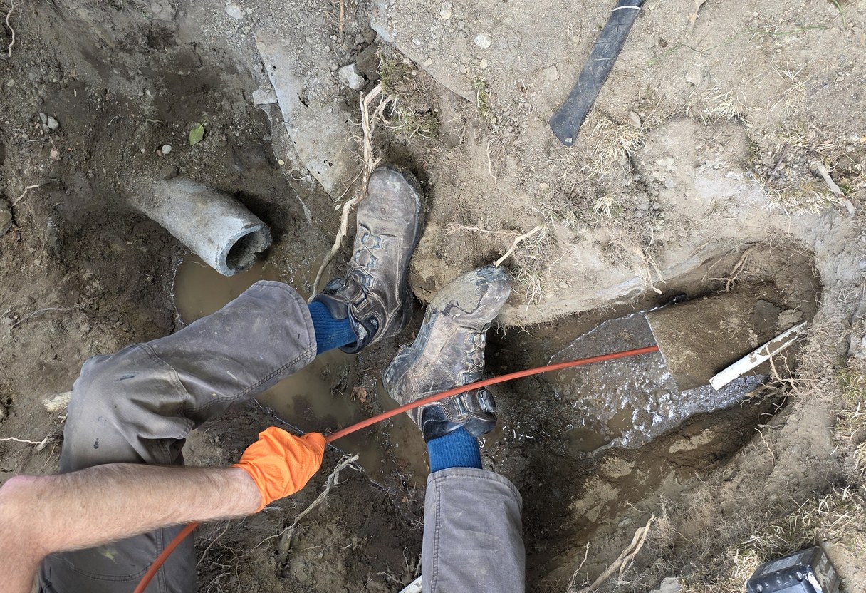 Crew working in an open trench on an old side sewer line